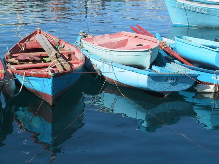 boats parked at dock next to each other