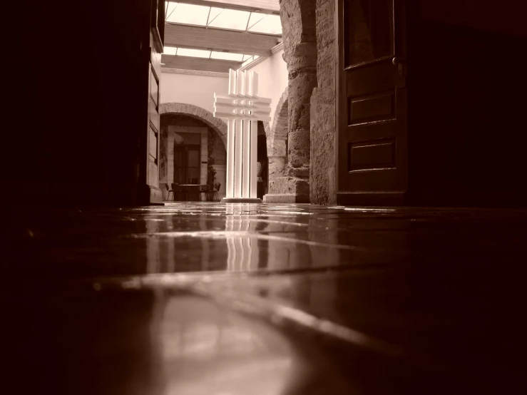 an open doorway to an empty building with brick pillars