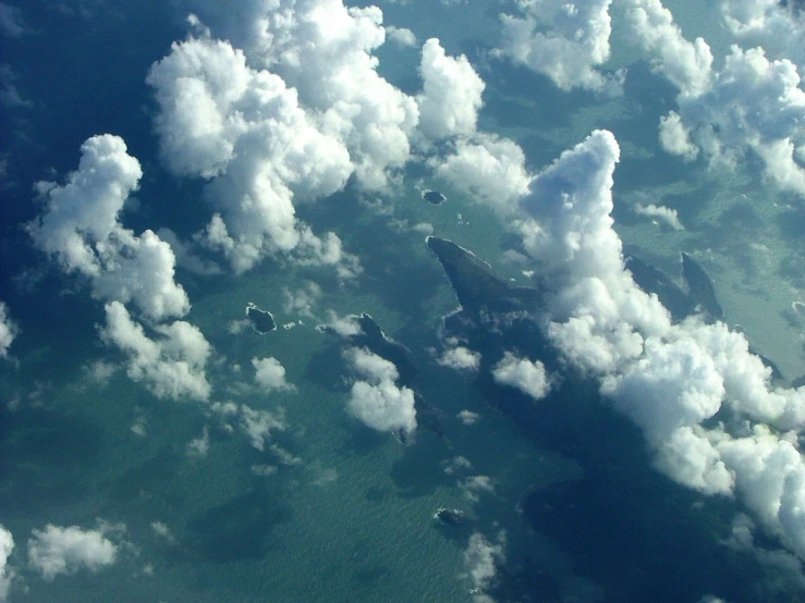 a plane is flying in the sky with clouds