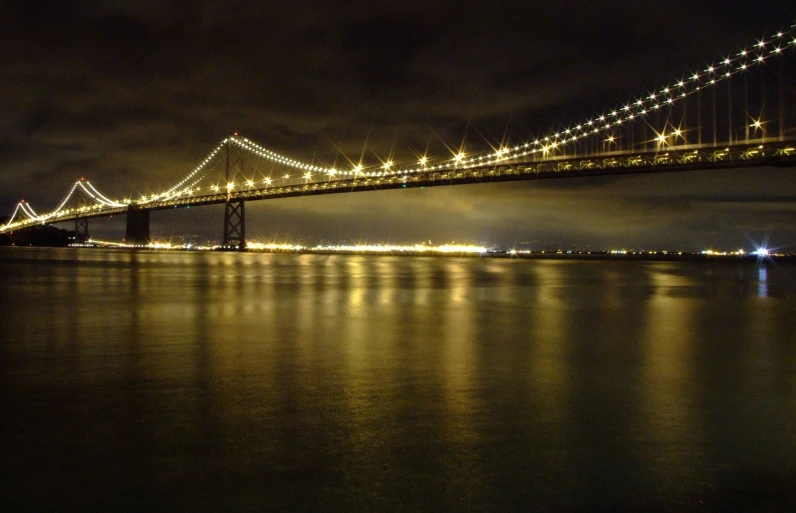 a long bridge with lights on above it