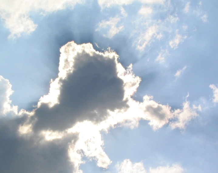 the sun shining through some clouds with one cloud visible