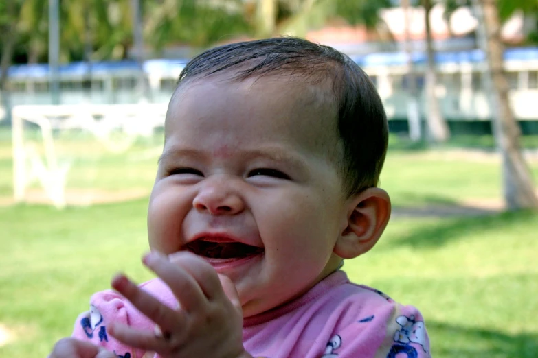 there is a baby in a pink shirt crying