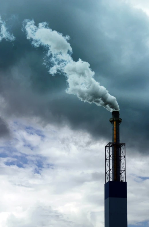 a tall metal chimney with steam rising out of it