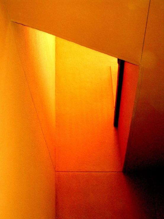 the hallway is lined with bright orange walls