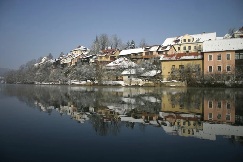 buildings in an old european town along the shore line, all by themselves