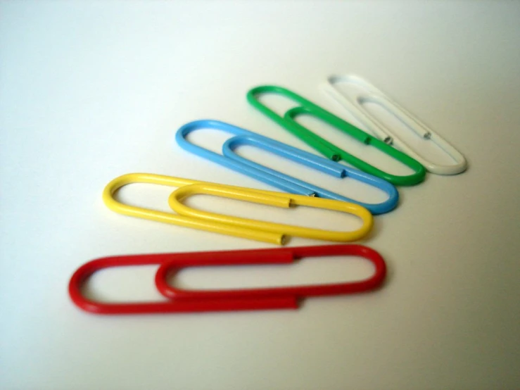 five different colored paperclips in a row