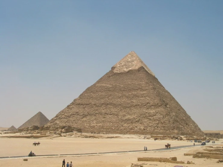 several people standing outside near the pyramids