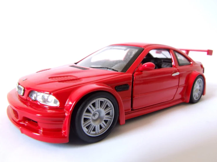 an action figure of a red car is on the table