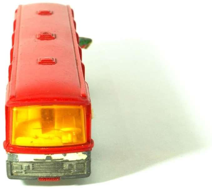 a red truck with yellow lights sitting on the floor