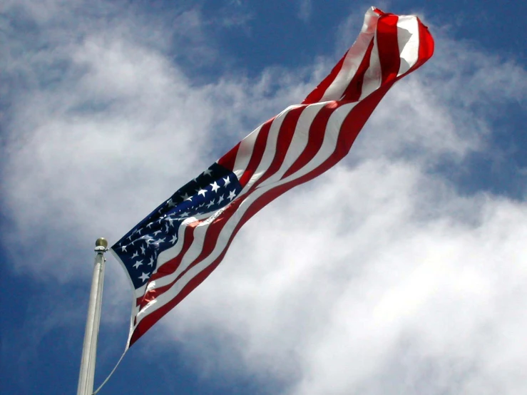 an american flag and another american flag fly in the air