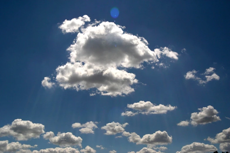 the sun is shining through a large cloud