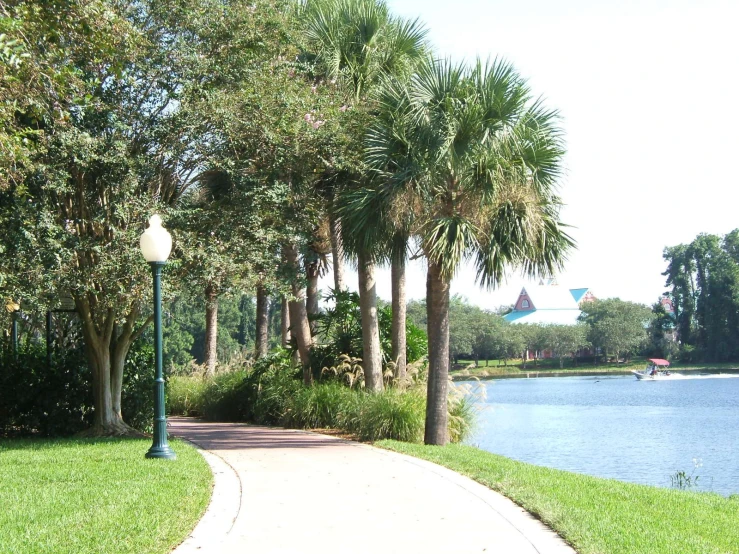 a park path near the water is empty