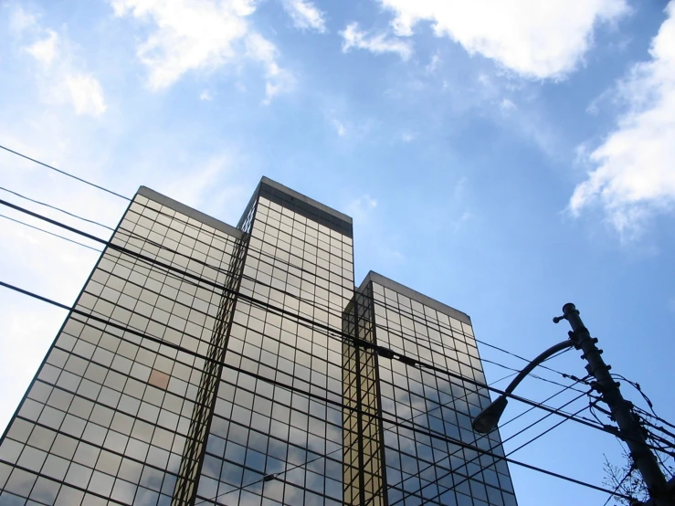 a view from the ground of the top of two tall buildings