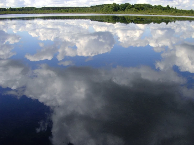 a reflection of clouds in the water