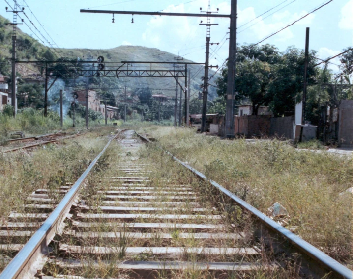 a train track sitting on the tracks in a rural area