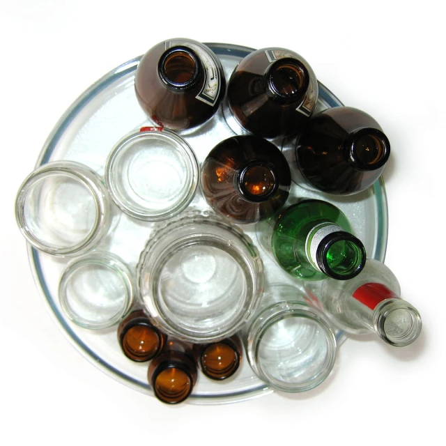 a group of glasses and bottles of liquor on a tray