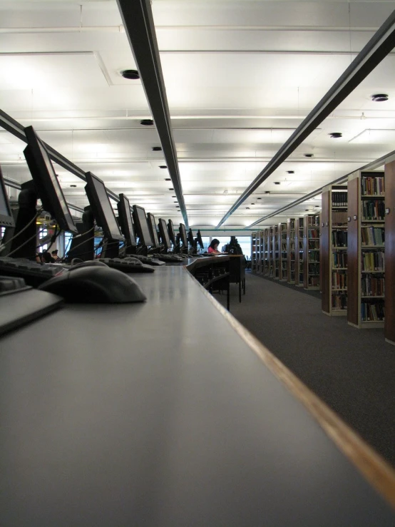 a liry has rows of computers and books in it