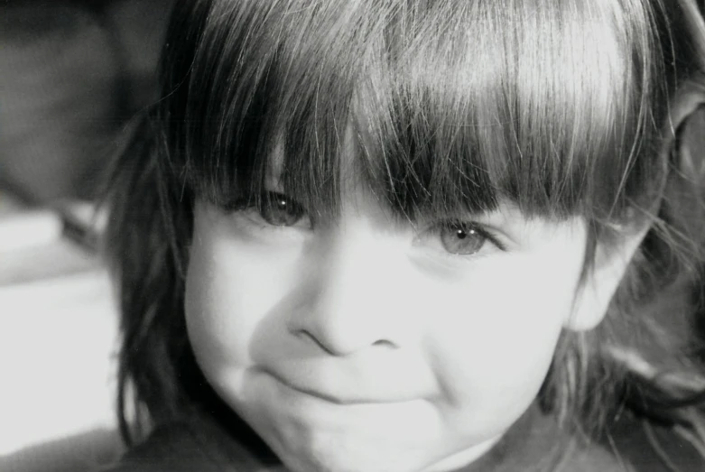 a little girl that is smiling at the camera