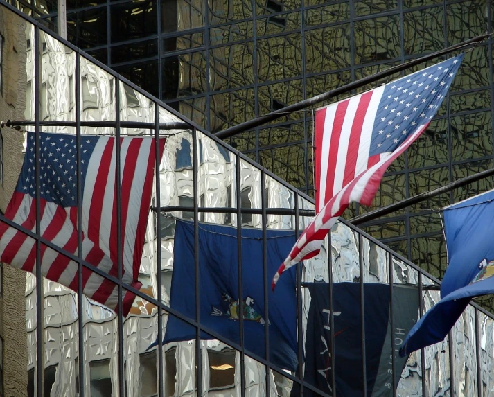 american flags fly on the outside of a building
