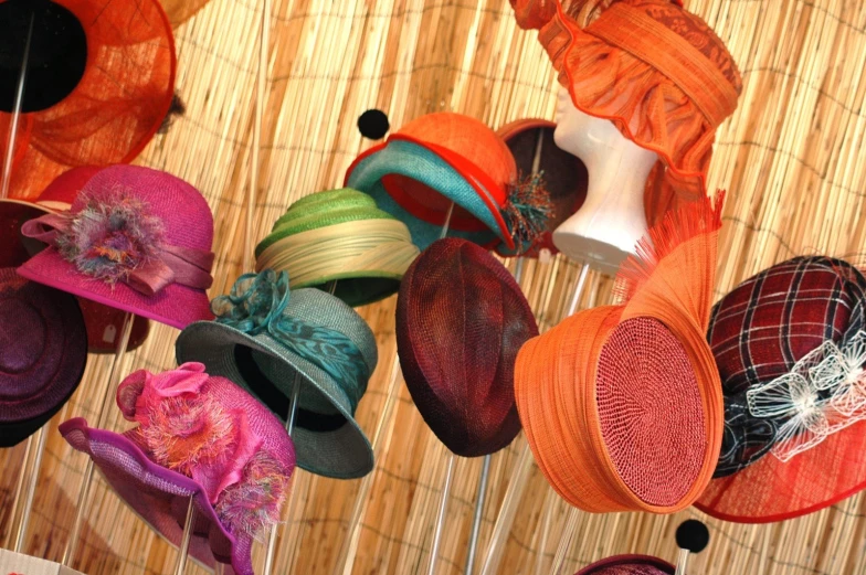 many different hats hanging on strings