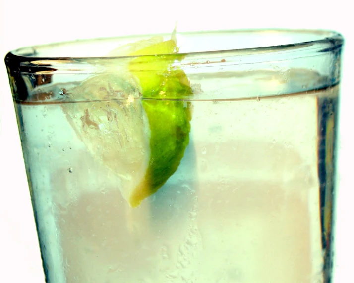 a s of ice water with lime slice and lemon wedge