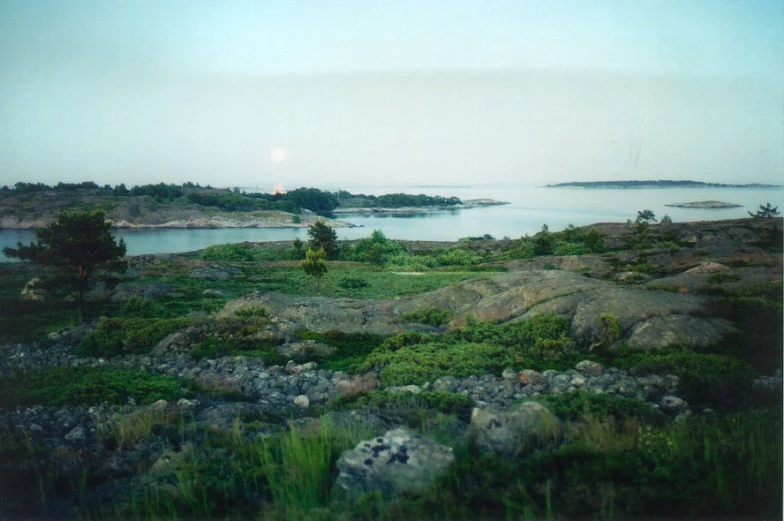 some rocks rocks and grass and a body of water