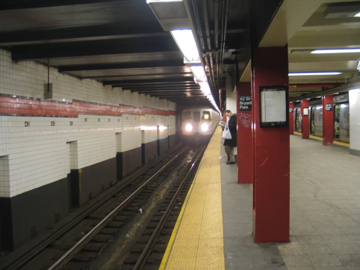 a train is pulling up to a subway station