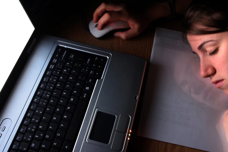 woman on the computer with the mouse on her lap