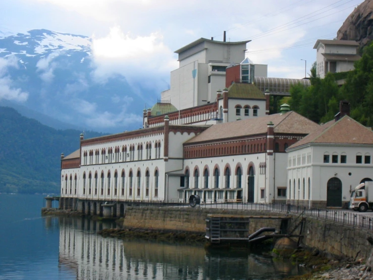 a large building on a small lake shore