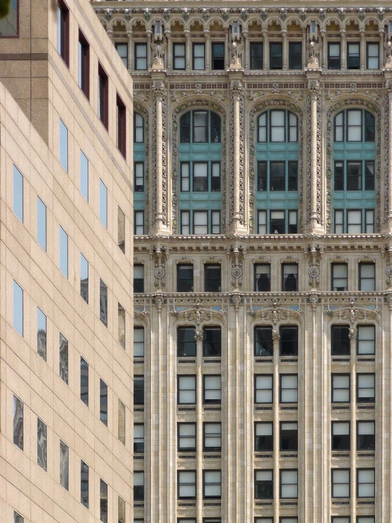 the reflection of a very tall building in the windows