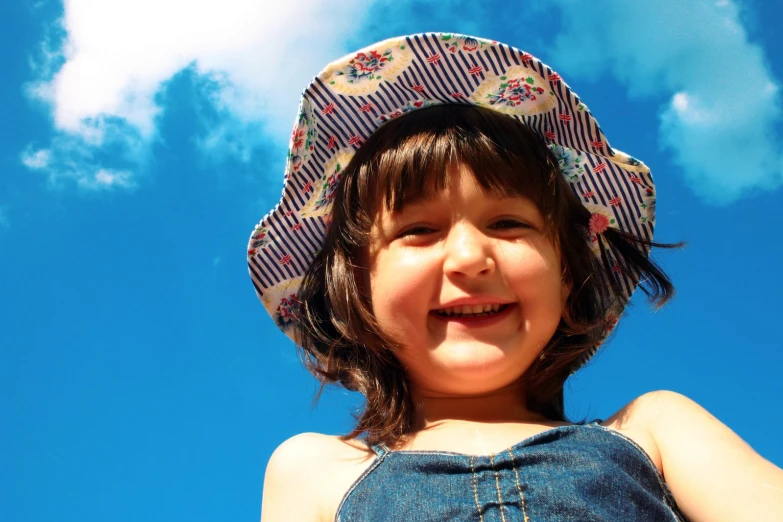 a girl smiles at the camera with her hair up