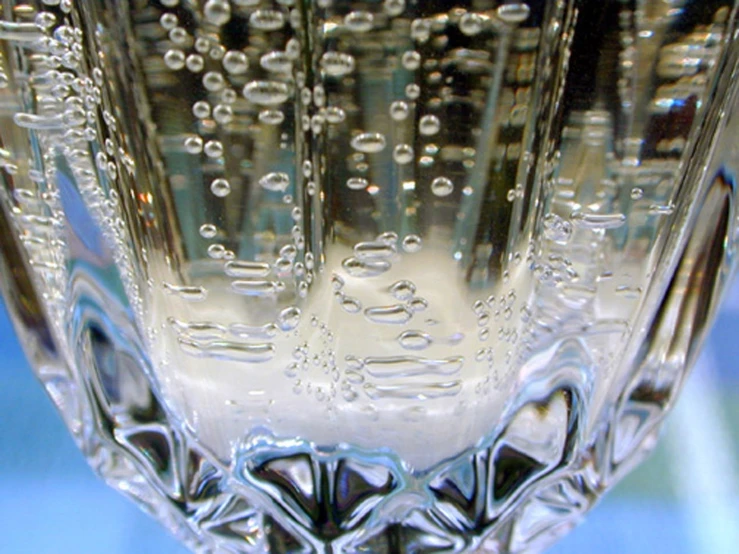 a large glass with liquid inside sitting on a table