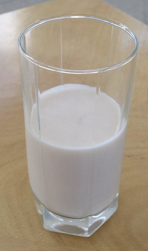the glass is filled with a small amount of milk