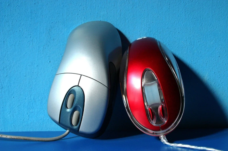 two computers sitting next to each other on top of a table