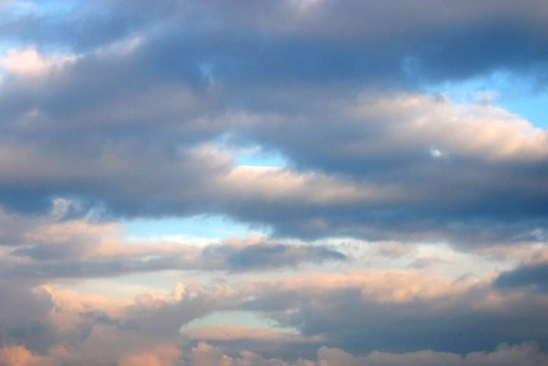 a plane is flying through a cloudy sky