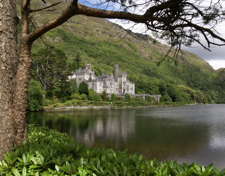 a scenic castle sitting on top of a lush green hillside