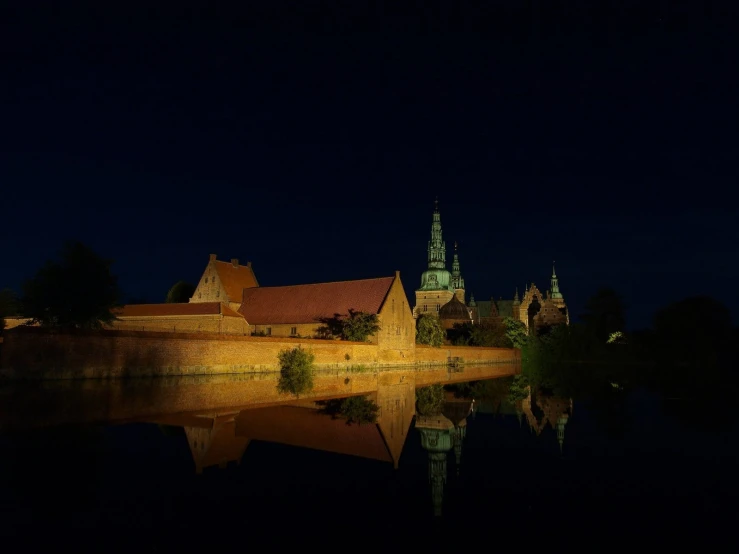 a castle is sitting next to some water