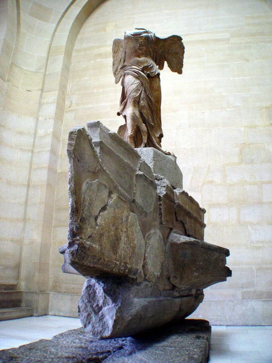 a large stone monument with a statue on top of it