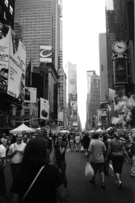 people are walking along a busy city street