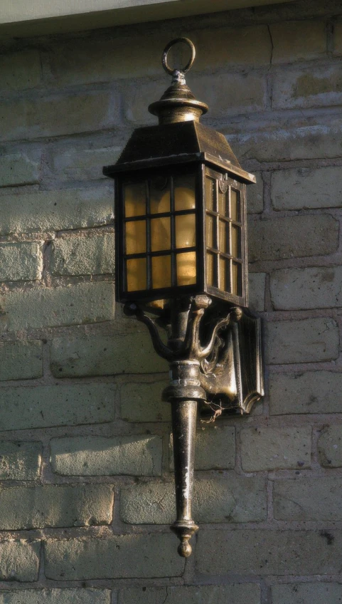 a lamp is seen on a wall outside