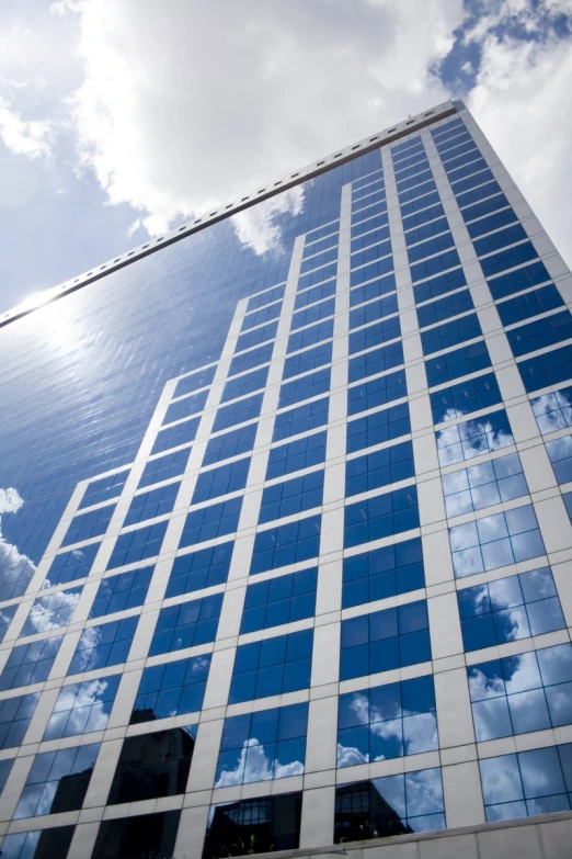 a tall building in front of some clouds