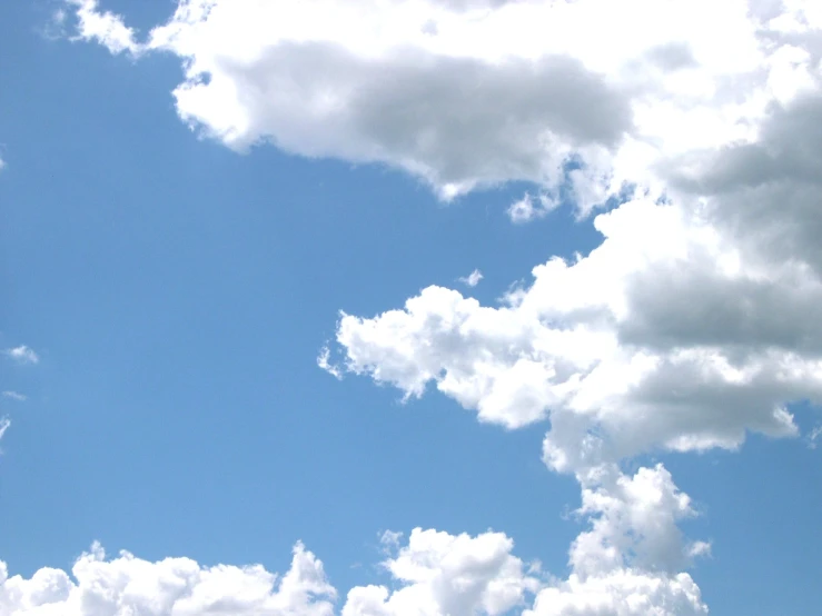 a plane is flying in the air in a clear sky