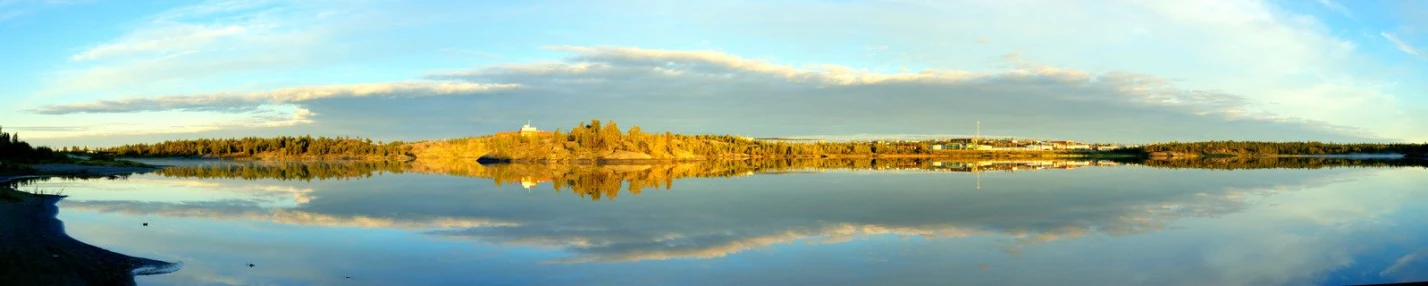 a lake with water and trees in the background