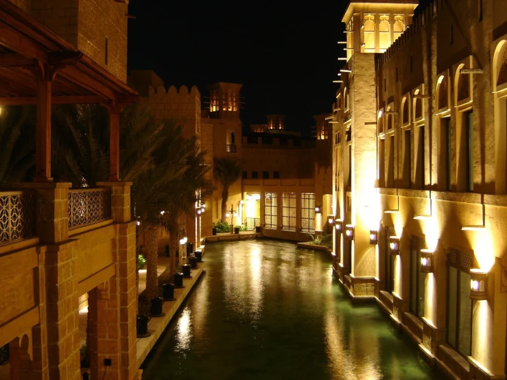 an empty canal in front of a building at night