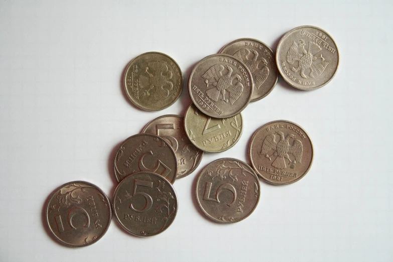 a pile of one pound coins sitting on top of a table