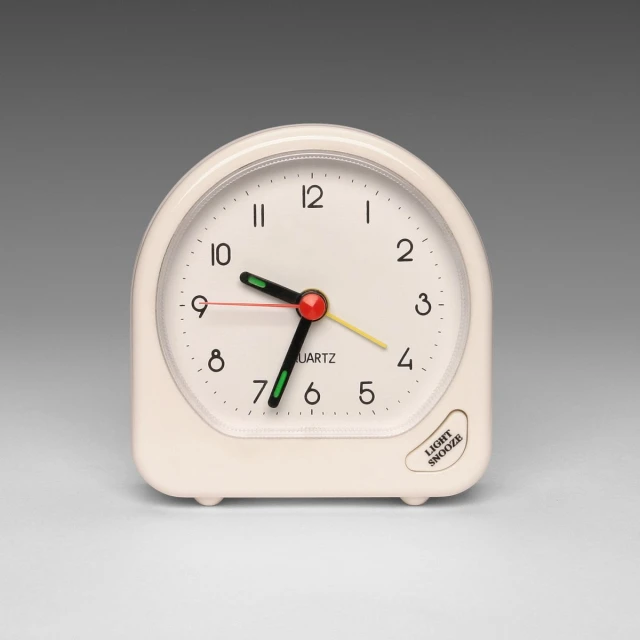 a small clock sitting on top of a table