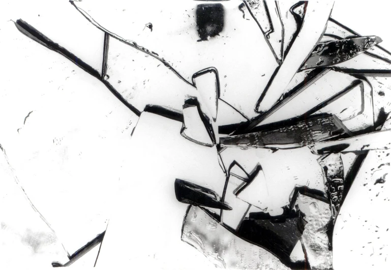 a black and white picture of abstract shattered objects