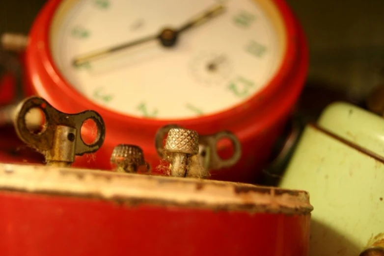 a close up po of some rusty keys and an old clock