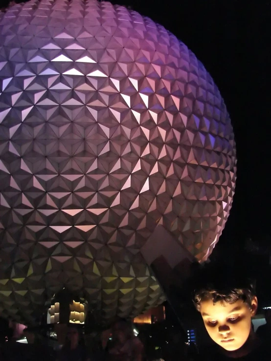 a man holding up his hand near the spaceship dome