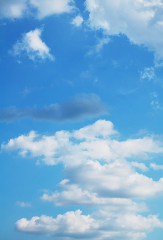 a kite flying high up in the blue sky